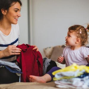 Frau macht mit Kind die Wäsche