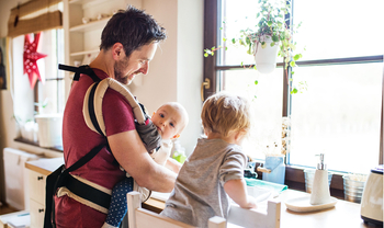 Vater macht den Abwasch mit zwei Kindern