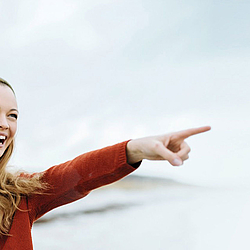 langhaarige Frau zeigt kleinem Mädchen etwas in der Ferne