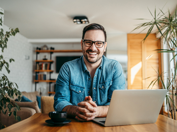 Mann mit Brille vor Laptop